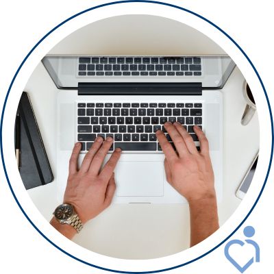 Hands typing on a laptop keyboard