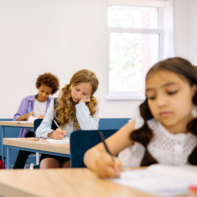 How to help a child who is restless in school 3 Students engaged in classroom activities, representing how to help a child who is restless in school
