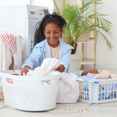 Helping children thrive with a summer routine 3 Child sorting laundry at home representing summer routine for kids